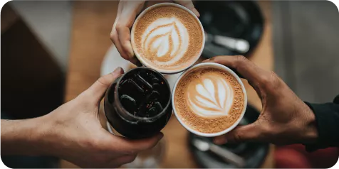 Top down view of three drink cups toasting