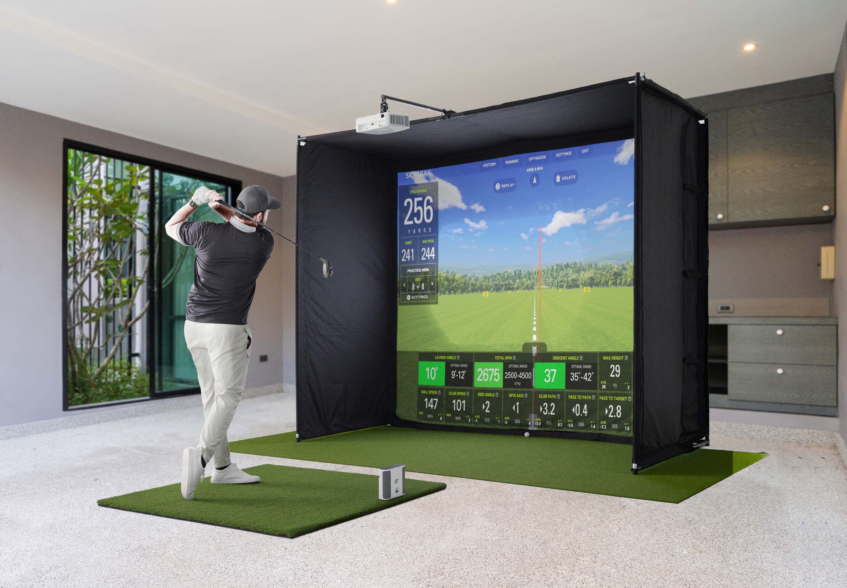 Man playing at indoor golf machine